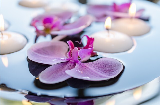 Floating candle and orchid flower